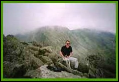 Larry on the top of Tryfan with a misty Glyders in the distance.