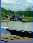Looking down the Hatton flight of locks. Noote St Mary's Chuch in Warwick can be seen in the distaance .