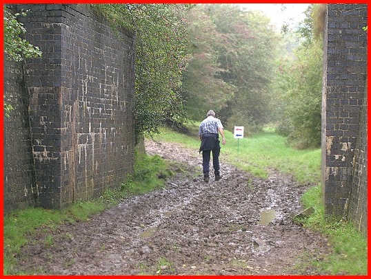 Mud by the old topless railway bridge .