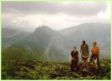 Ian, Greg and Anne and a wonderful view of the west side of Tryfan with Bristley Ridge and Glyders on its right .