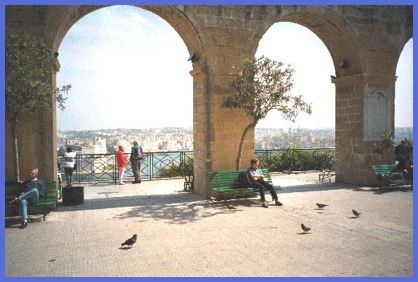Anne, resting in the Upper Barrakka Gardens, with the Grand Harbour and the Three Cites in the background.
