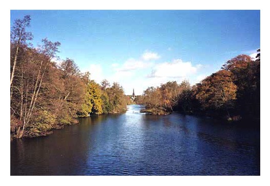 The view from the bridge looking north east up the lake with Clumber Chapel in the distance