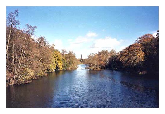 The view from the bridge looking north east up the lake with Clumber Chapel in the distance