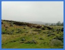 At the top of Padley Gorge with Carl Wark Hill Fort and Higger Tor in the distance .