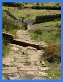 Anne, with trouser legs, at the start of the rock steps on Pendle Hill .