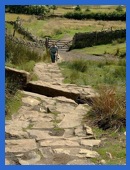 Anne, with trouser legs, at the start of the rock steps on Pendle Hill .