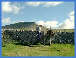 Anne at a ladder stile near Brackenbottom with another view of Pen-y-ghent .