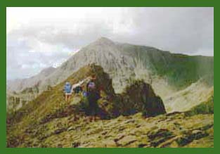 Going over Crib Goch . Snowdon can be seen beyond.