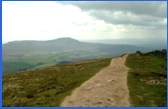 The start of the descent from Whernside with Ingleborough in the distance .